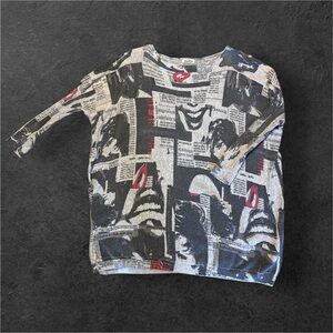 Black & white newspaper print sweater with red accents